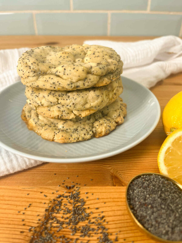 Stack of lemon and poppyseed cookies with lemon and poppy seeds